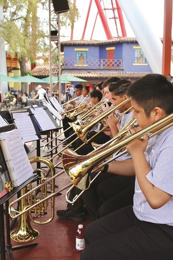 Trombone players of the Mater Dei Music Academy performing at a local amusement park