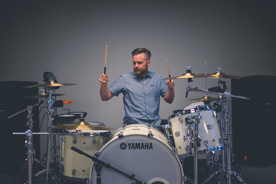 male playing drums