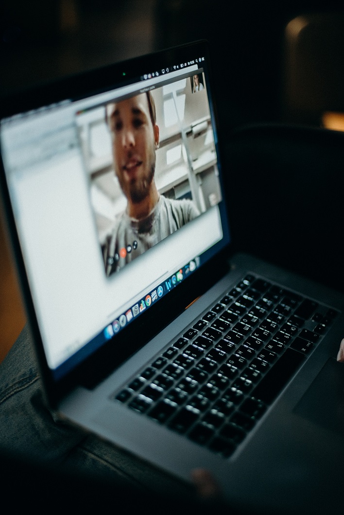 one-on-one digital meeting -- laptop screen showing a male's face