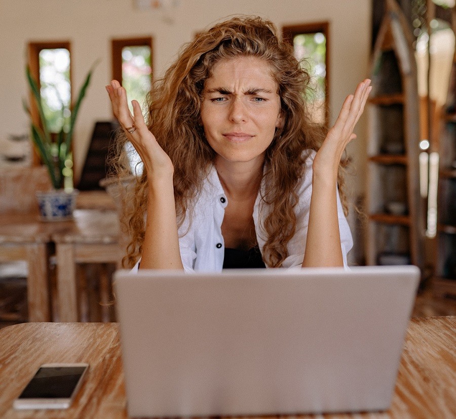 frustrated woman looking at her laptop