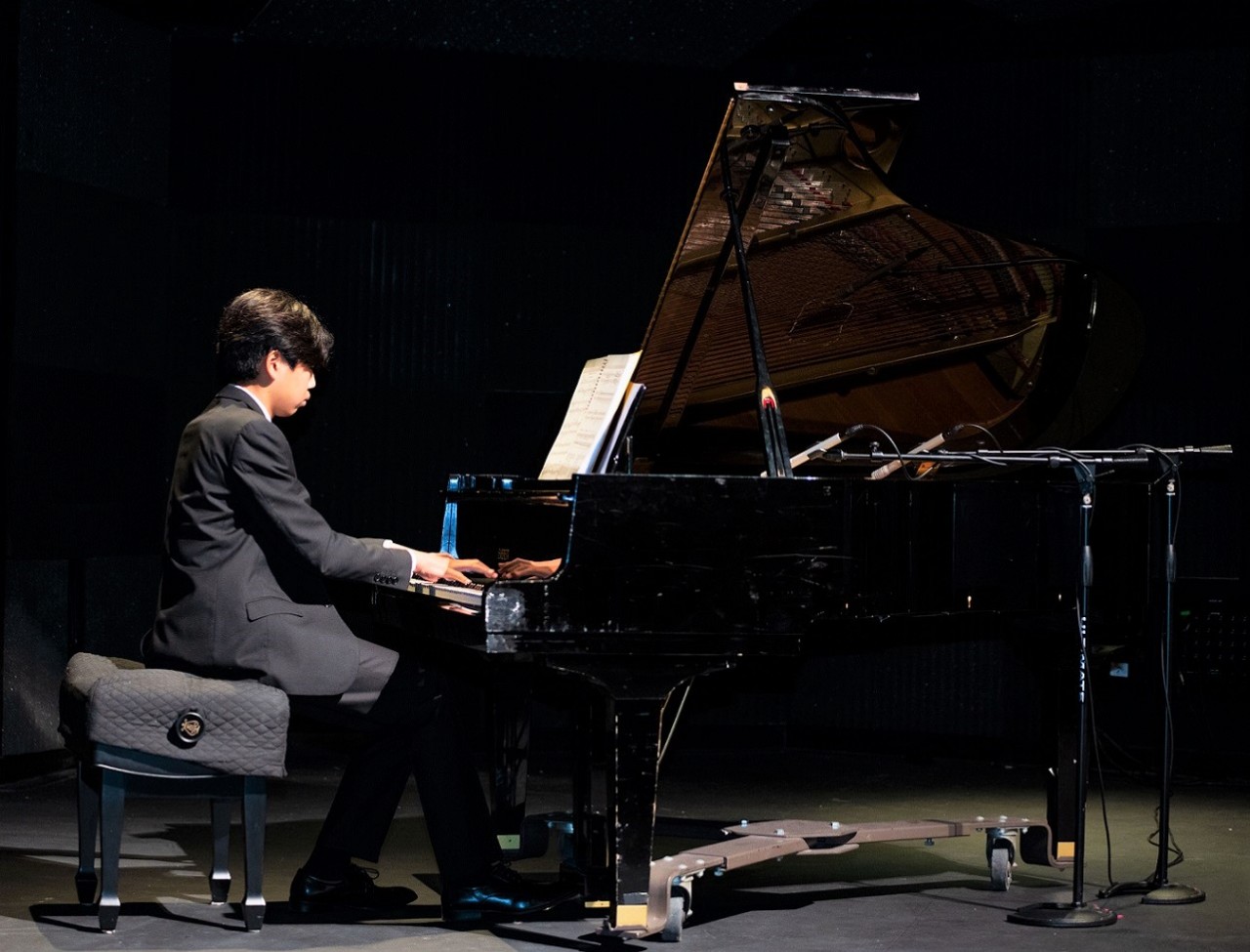 male student playing the piano