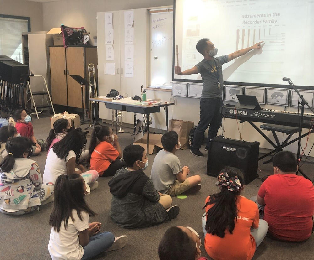 EJ Villanueva showing the recorder to 3rd graders 