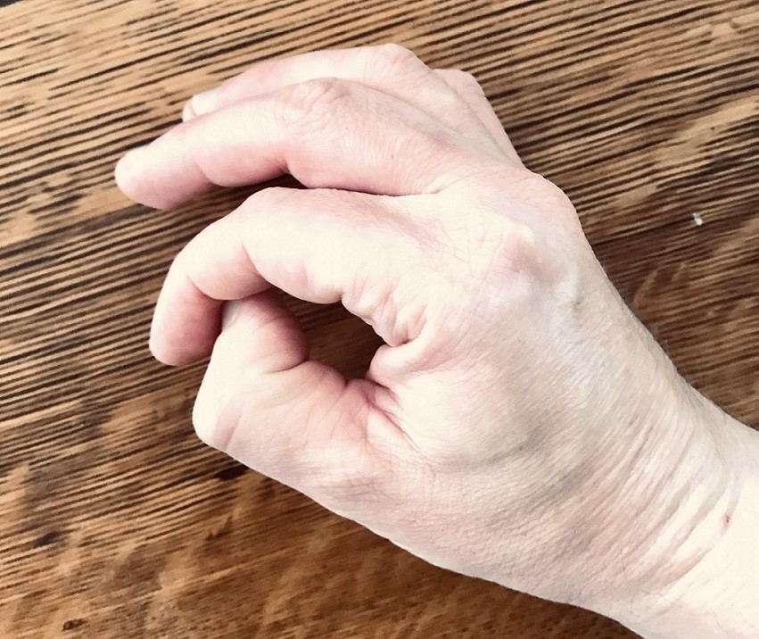 hand making O shape to feel the correct part of the fingertip used in piano playing 