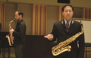 Kenneth Tse with student, both with saxophones