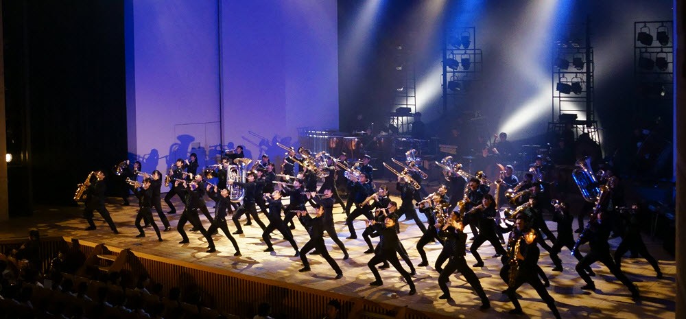 Members of the Kashiwa Municial Senior High School band performing on stage.