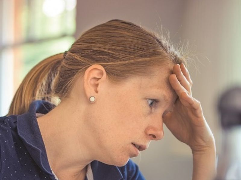 frustrated woman with hand on her forehead 