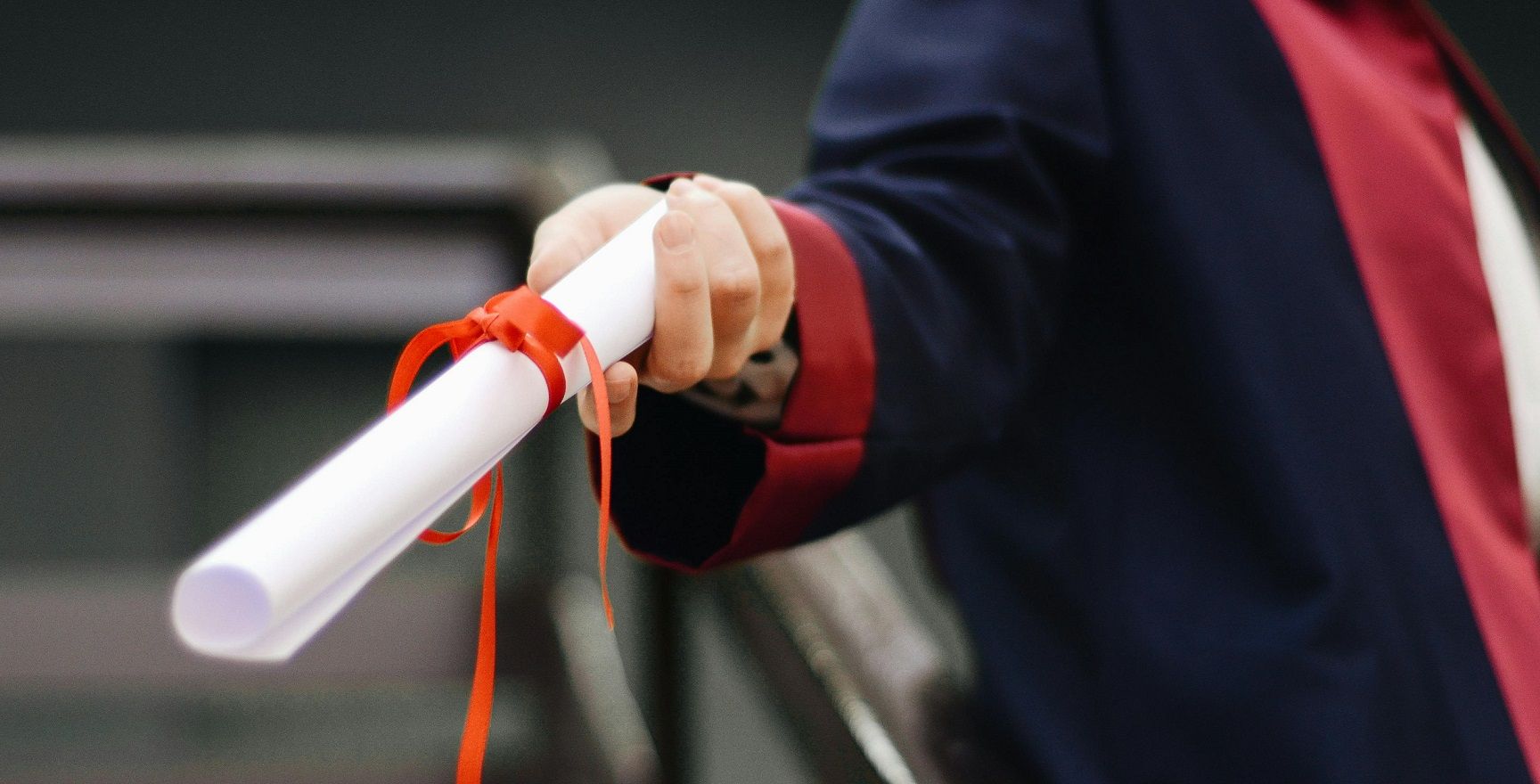 hand holding diploma