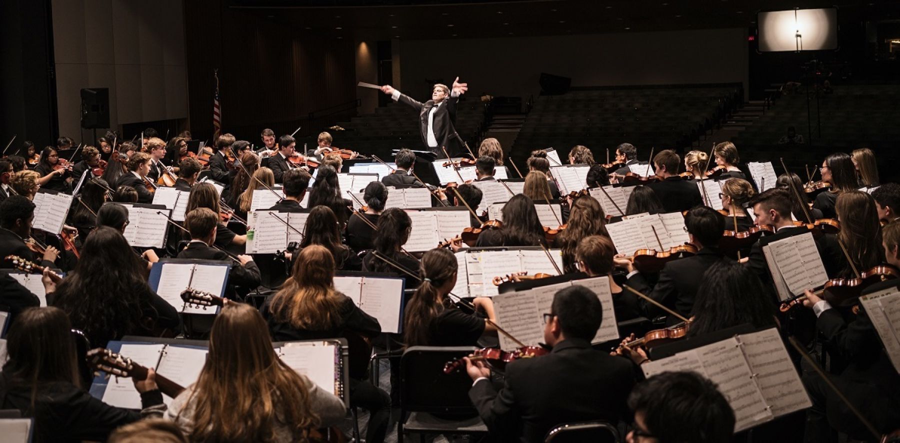 Orchestra being conducted.