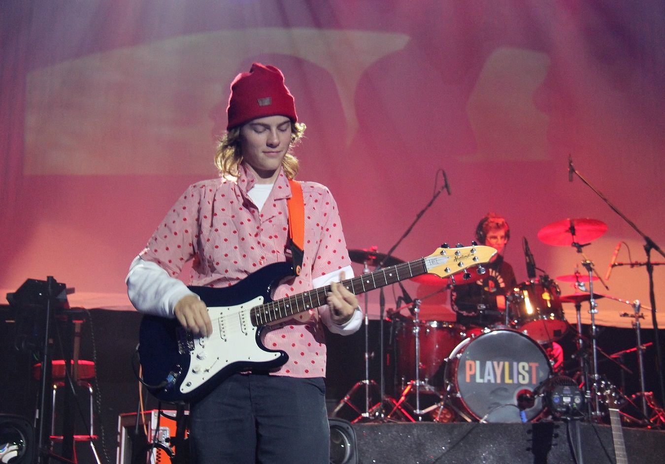 student playing guitar on stage 