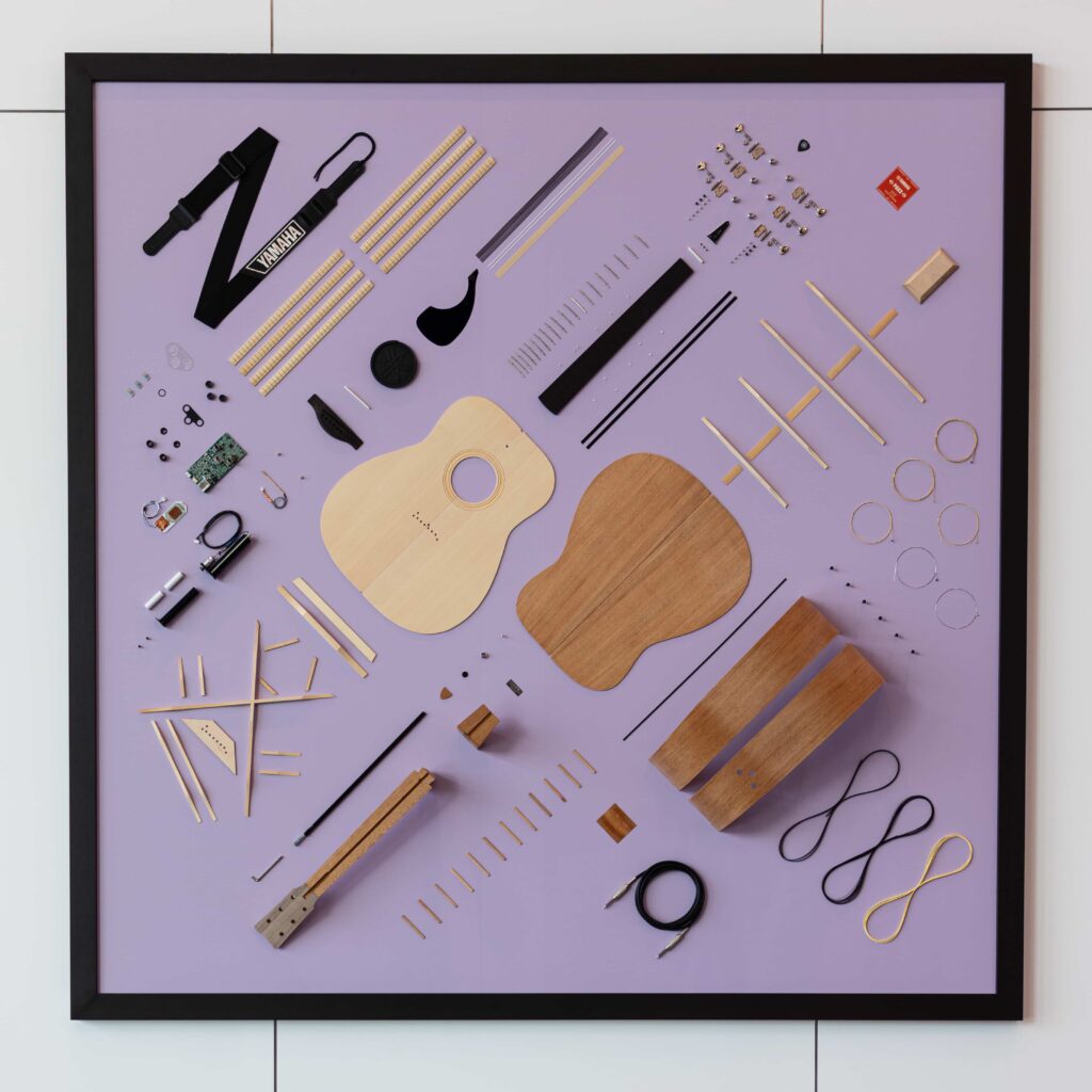 A close-up view of a unique art piece based around the exploded view of an acoustic/electric guitar.
