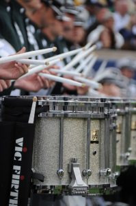 Drumsticks playing marching snare drums.