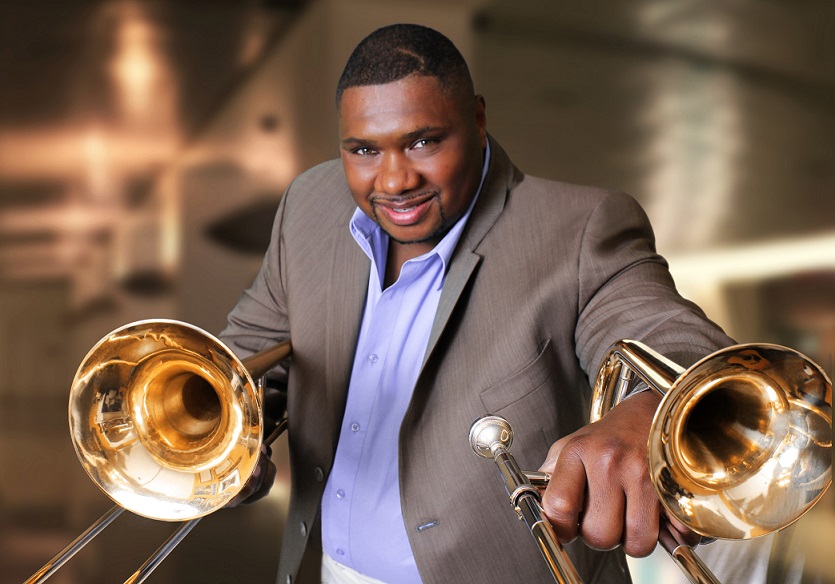 Wycliffe Gordon holding two trombones