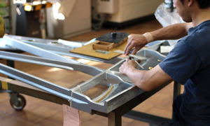 Man assembling pieces of an acrylic piano.