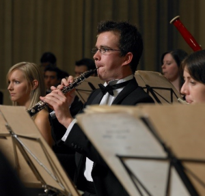 oboebodyimage Man playing oboe in an orchestra.