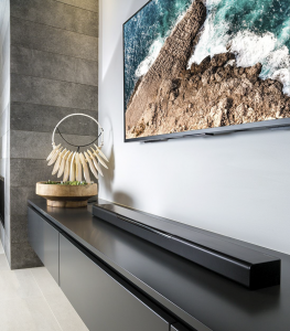 yamaha sound bar 400 Long horizontal sound bar sitting on a console right below the large flat screen tv.