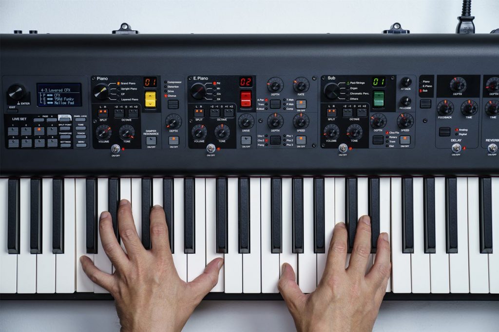 Two hands playing an electronic keyboard.