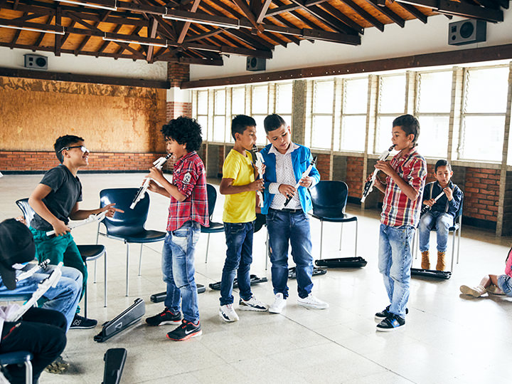 Venova Body Image 1 A group of children playing musical instruments.