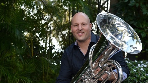 Aaron Tindall holding tuba