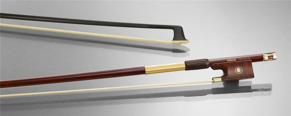 yamaha bows Closeup of two carbon bows for stringed instruments.