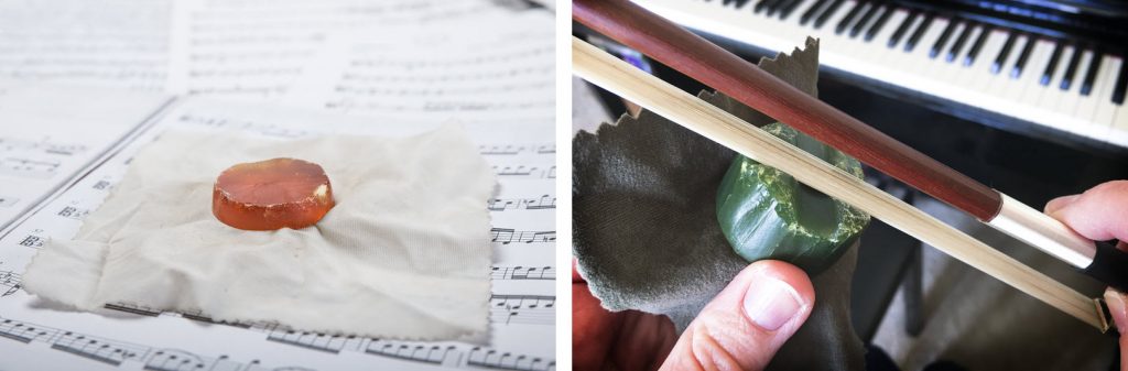 bow wax combo Two views of bow resin. On left, a small patty unwrapped sitting on its wrapper which is sitting on sheet music. On right a closeup of someone applying resin to a bow. There is a piano in the background.
