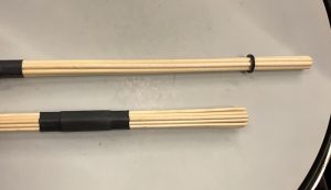 rods_2 Two multi-rod drumsticks. One is longer and has fewer sticks than the other.