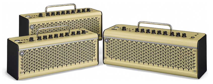 Three small box shaped guitar amplifiers with handles.