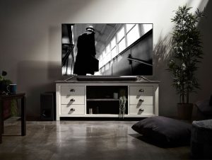 Living room entertainment center with television and sound bar.