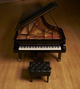 CFX_Segerstrom-93b66379 Yamaha CFX grand piano on wooden stage.