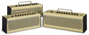 Three small rectangular portable guitar amplifiers.