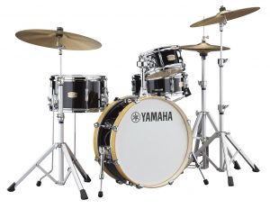 Black drum set with bass drum, two tom drums, snare drum, two cymbals & a hi-hat.