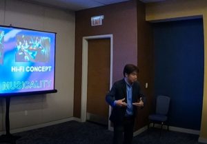 Man in professional attire gives presentation on Hi-Fi 5000 series.