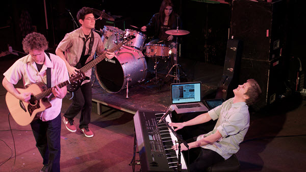 Group of young friends performing on stage.