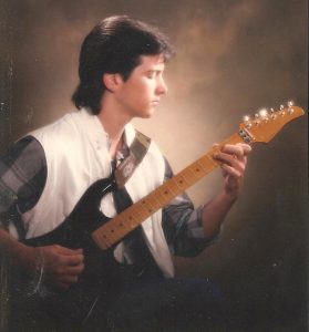 Butch-TBT2 A young Butch Walker playing guitar.