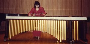 Woman playing a marimba.