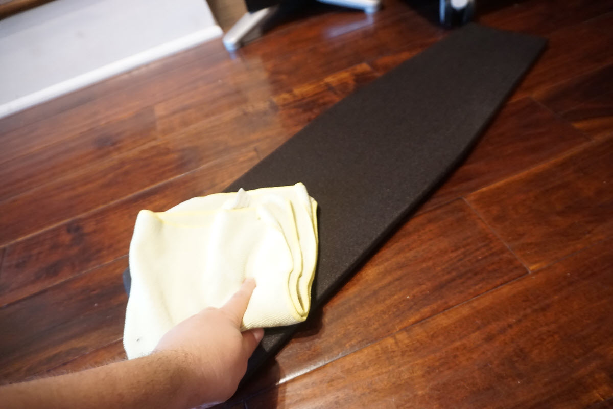 howtocleanaudio2 Closeup of someone's hand with soft cloth cleaning a speaker grill.