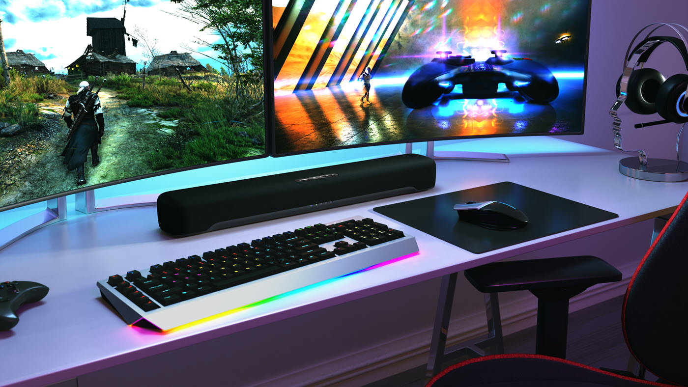 C20_GAM1-1400 Gaming setup with three desktop screen, controller and keyboard. There is also a long horizontal sound bar speaker centered below screens.