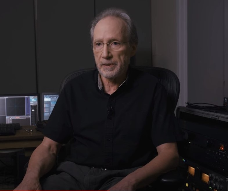 Older man sitting in front of a digital sound workshop.