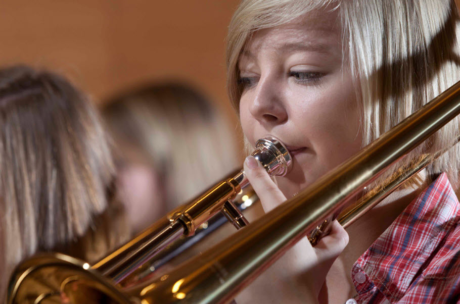 brass-2. Young girl playing trombone.