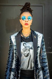 JUNO Photograph of a young woman wearing sunglasses.
