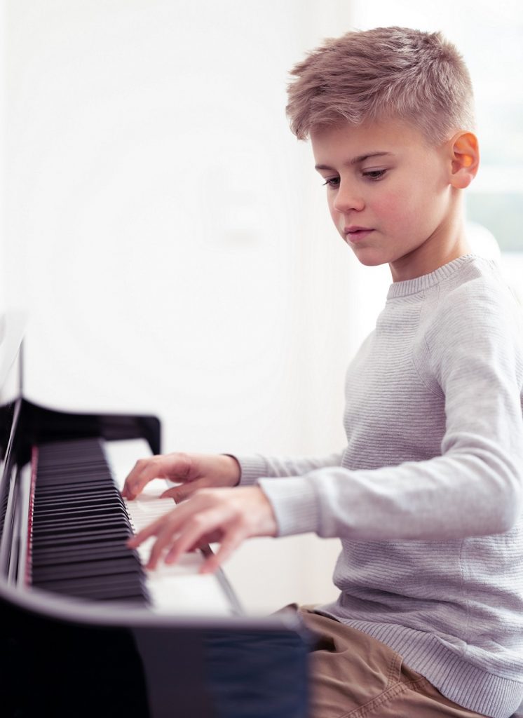 boy playing the piano