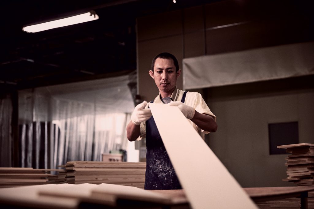 Piano-being-made Man working on building a piano.