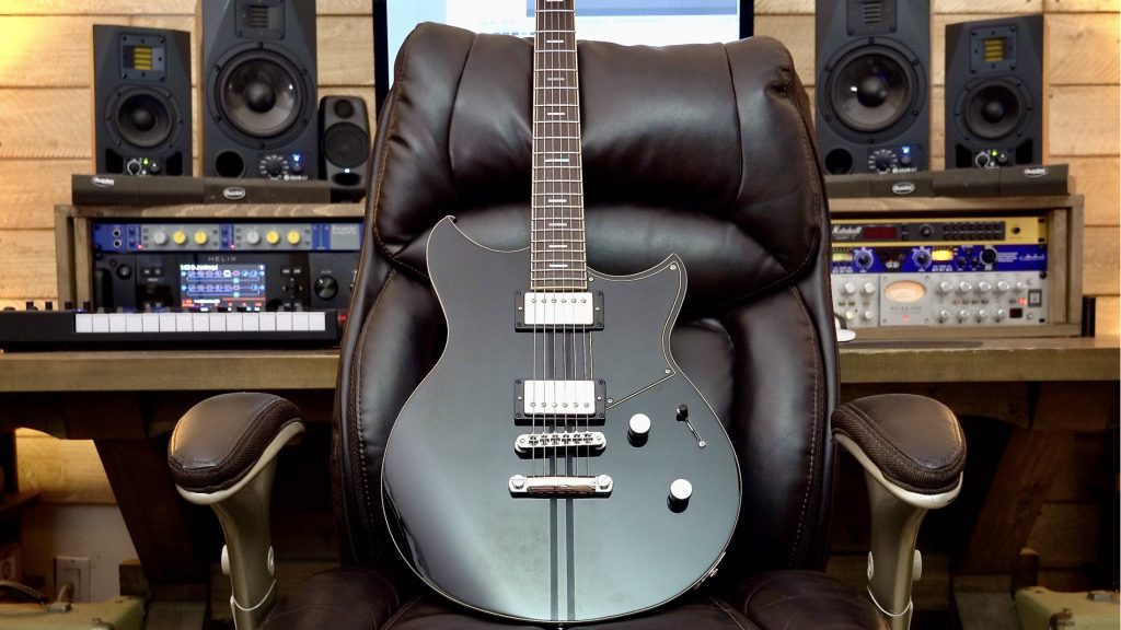 Beautiful electric guitar propped up on a leather chair in a sound studio.