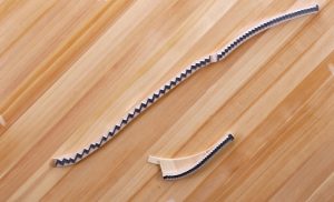Wood parts used for the bridge of an upright piano.
