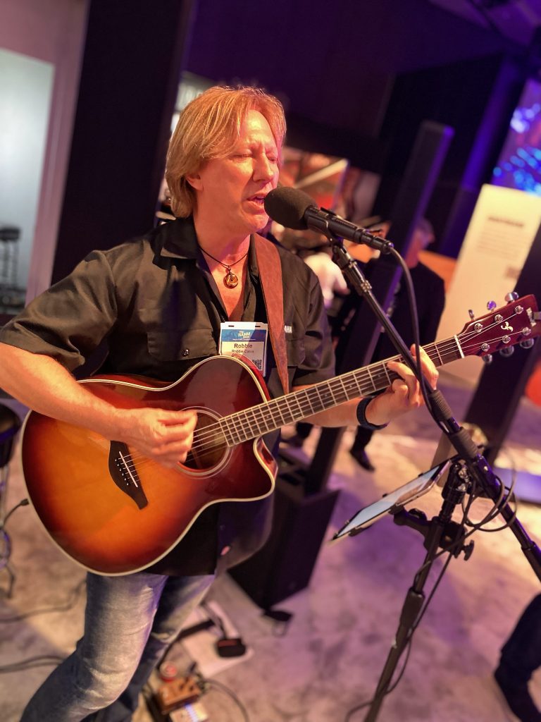 Robbie Calvo playing guitar and singing.