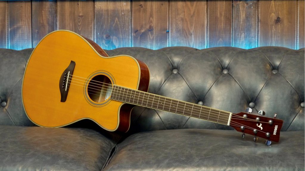 GTR-STILL-2-2-resized Guitar on its side on a leather couch.