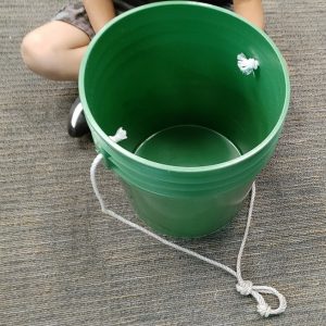 green bucket with attached cord