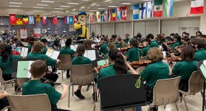 Edwin H. Greene Intermediate School orchestra performing with school mascot