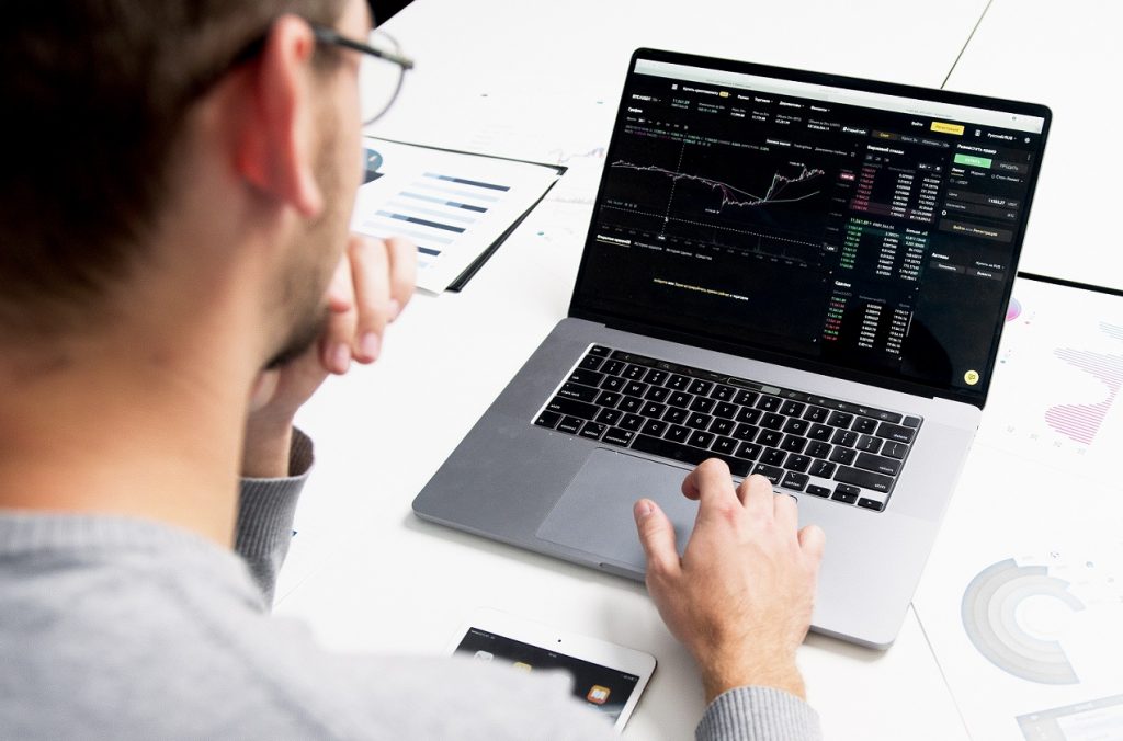 man monitoring budget on laptop