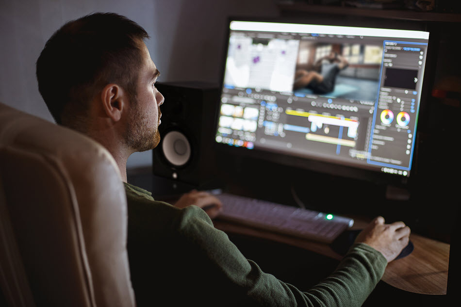 Guy in front of home studio computer.