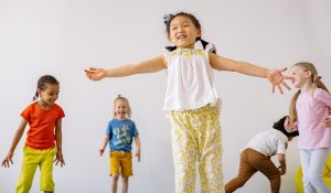 five elementary school students dancing